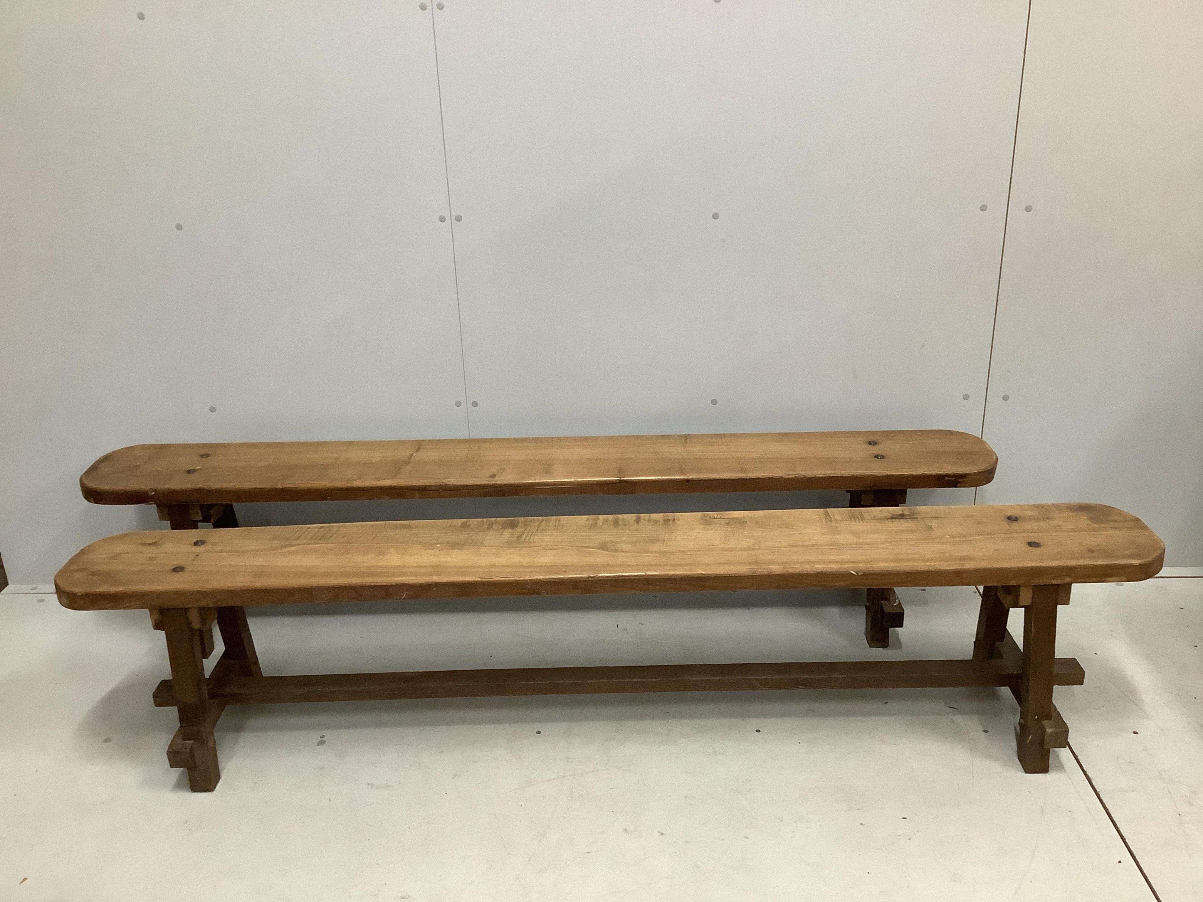 A 19th century French oak plank top kitchen table, width 198cm, depth 92cm, height 71cm, together with a pair of 19th century French oak benches, length 200cm, depth 24cm, height 42cm. Condition - fair